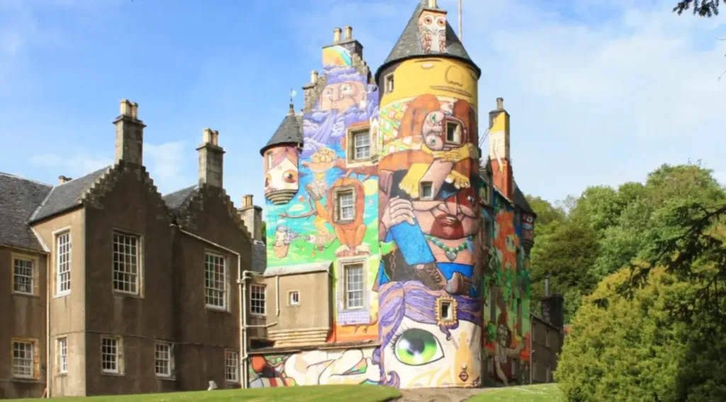 A castle with graffiti on the side